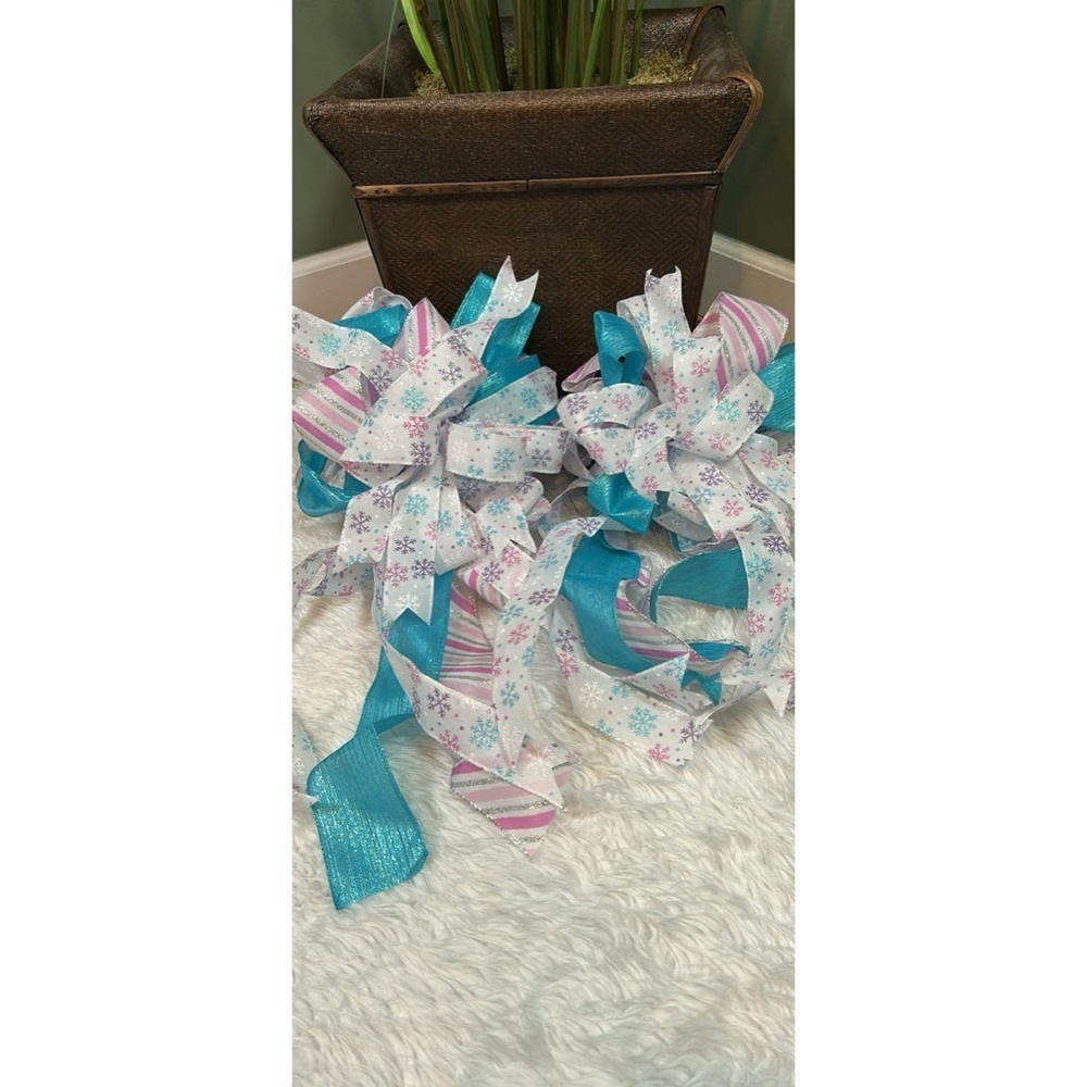 Two frozen themed Christmas tree, toppers, multiple bows, and extra ribbon